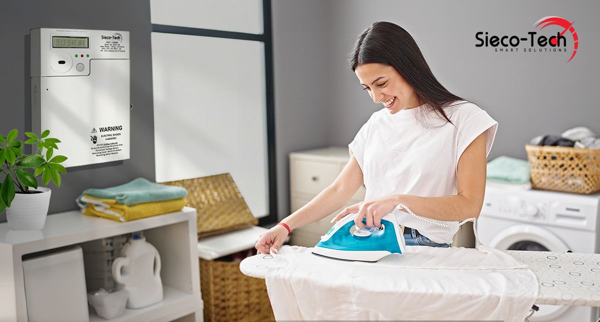 A woman ironing clothes and an electrical sub-meter is pictured in the background